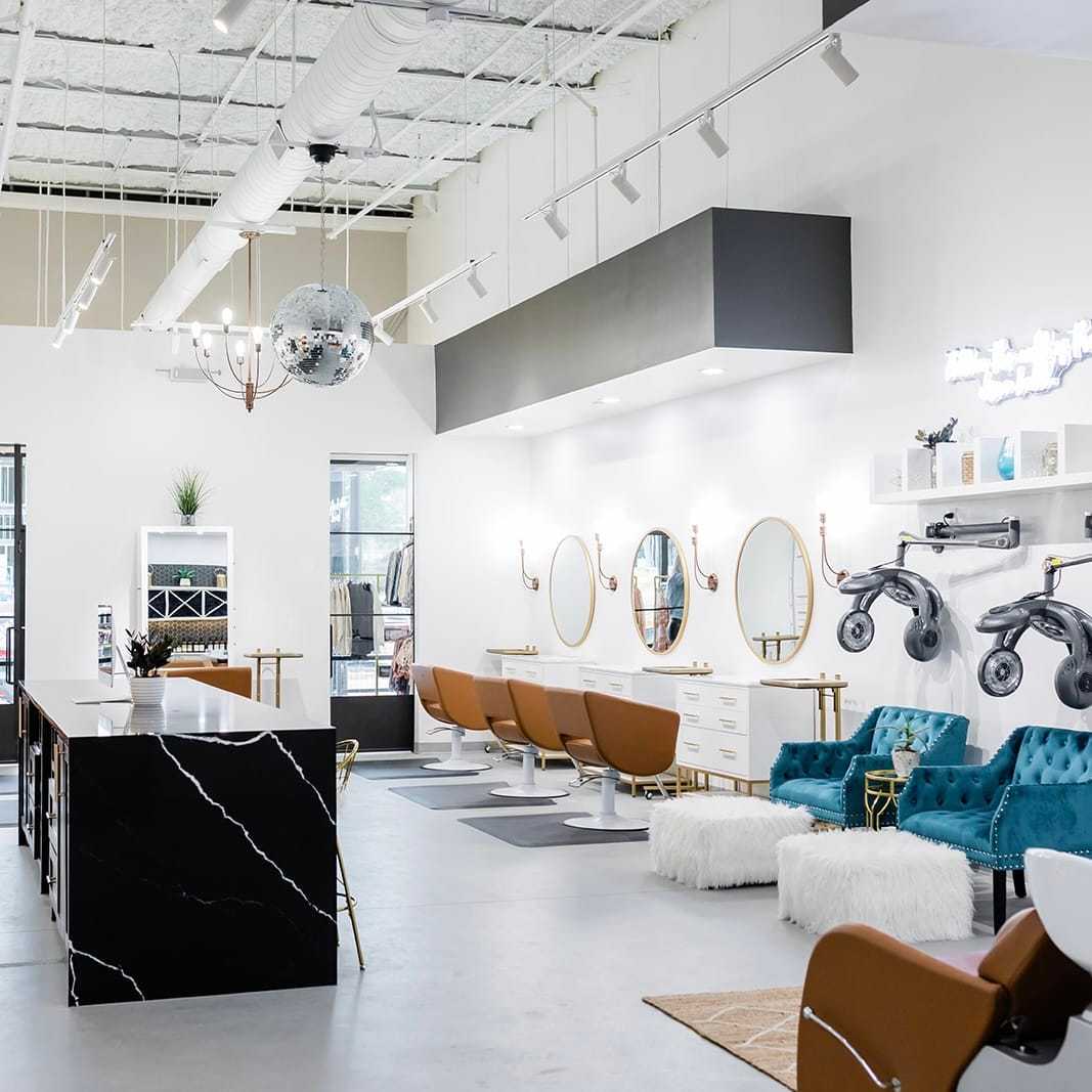 Modern salon interior with styling chairs, mirrors, and chic decor.