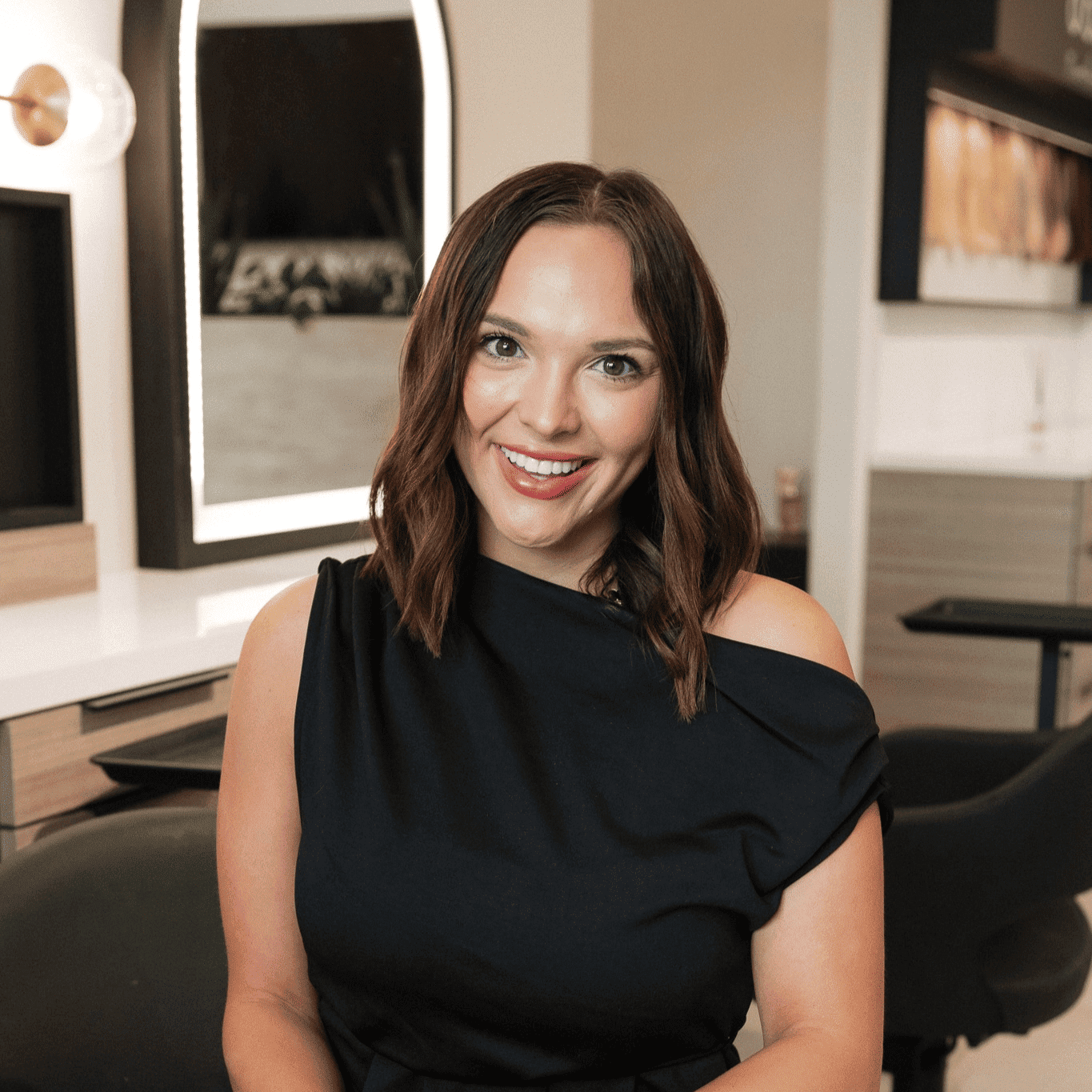 Portrait of Bri, a professional stylist at Bonjour Belle Salon, showcasing their expertise and style.